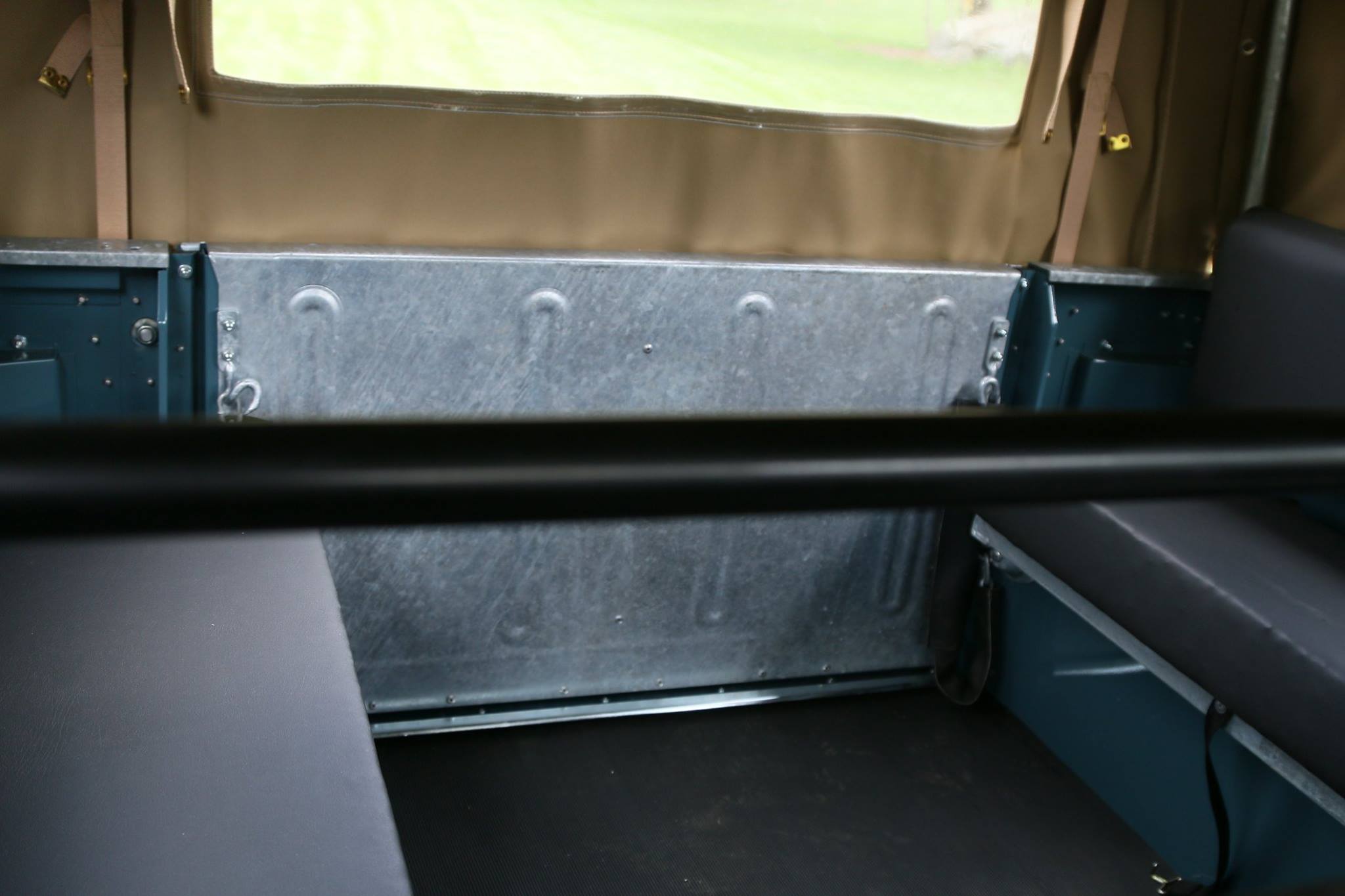 A shot of the rear load bay showing the galvanzied tailgate panel and jump seats.