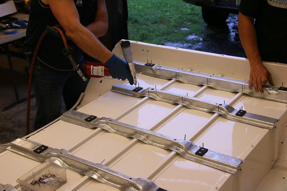 Riveting galvanized underbody supports to a freshly painted rear tub.