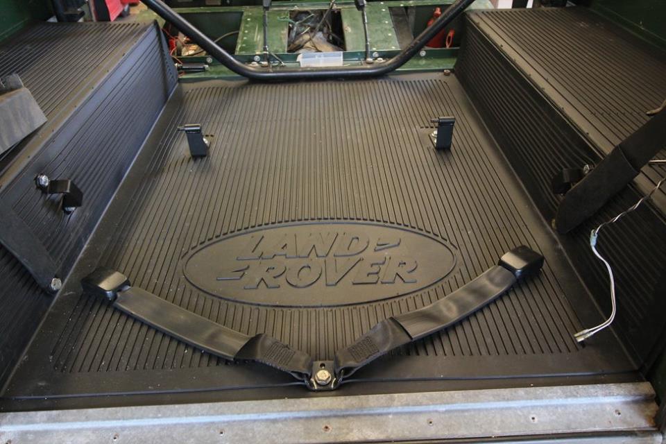 A new genuine Land Rover rear mat is installed.