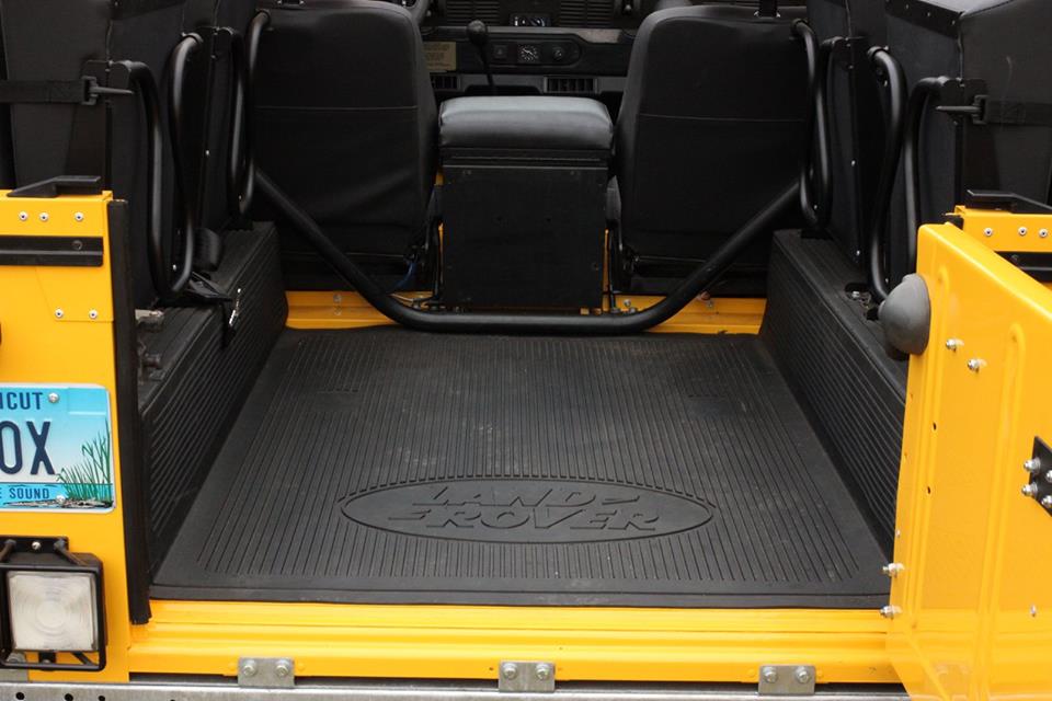 A new genuine Land Rover rear floor mat is installed.