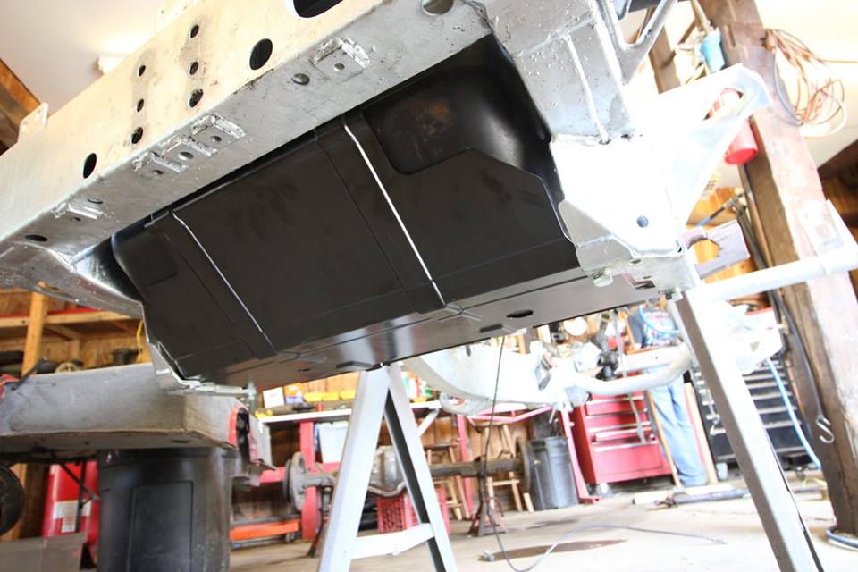 A new genuine Land Rover gas tank skid plate is installed.