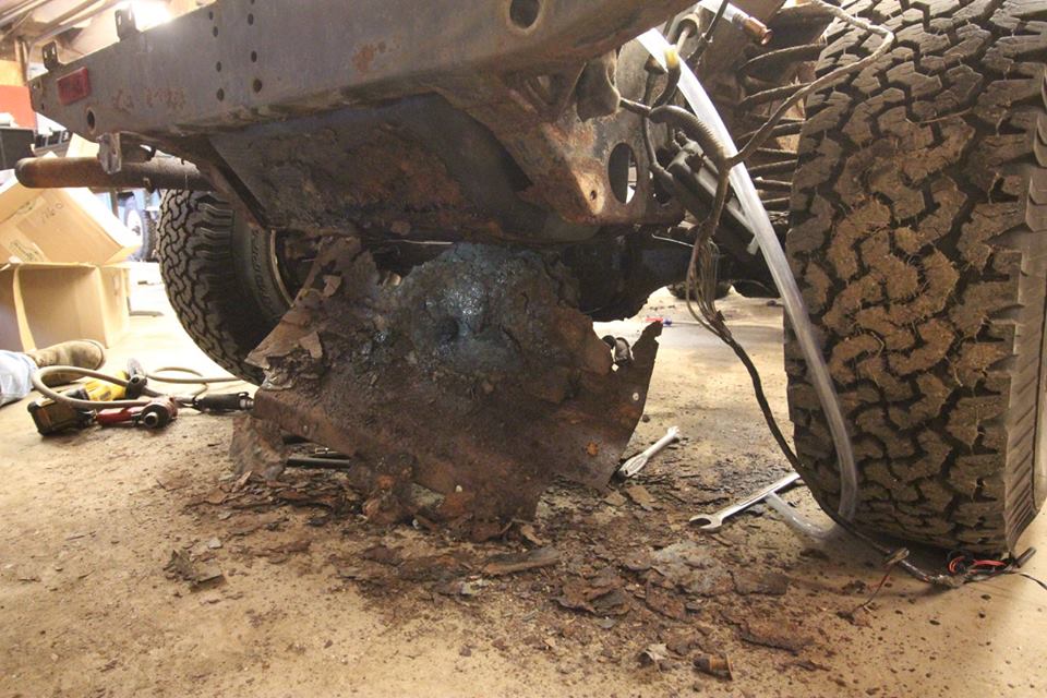 Major rot is clearly visible on the gas tank skid plate and frame.
